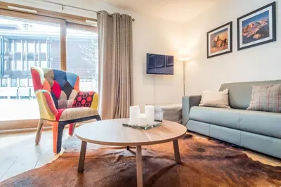 a living room with a couch and a table at Grand Paradis in Chamonix-Mont-Blanc