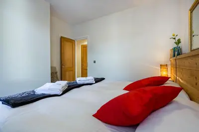 a bedroom with a large bed with red pillows at Lodge aux Praz in Chamonix-Mont-Blanc