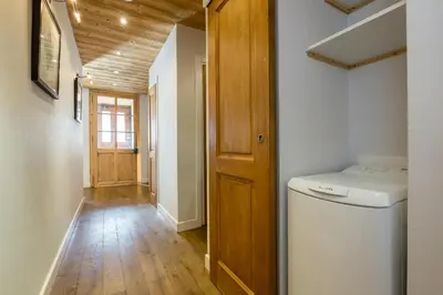 a hallway with a washer and dryer in a house at Lodge aux Praz in Chamonix-Mont-Blanc