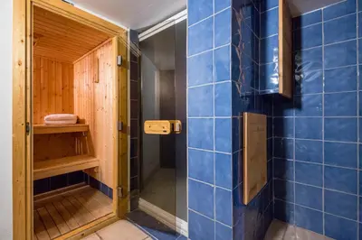 a bathroom with blue tiled walls and a shower at Lodge aux Praz in Chamonix-Mont-Blanc