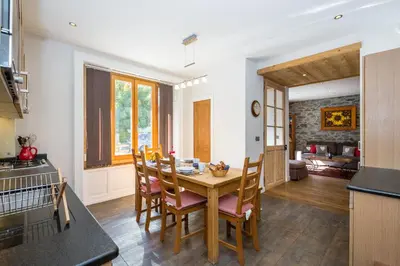 a kitchen and dining room with a table and chairs at Lodge aux Praz in Chamonix-Mont-Blanc