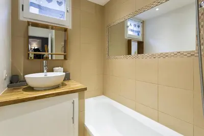 a bathroom with a sink and a mirror at Apartment Triolet Jardin - Garden with Mont Blanc Views in Chamonix-Mont-Blanc