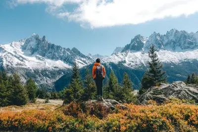 a man standing on top of a mountain looking at the mountains at Apartment Triolet Jardin - Garden with Mont Blanc Views in Chamonix-Mont-Blanc