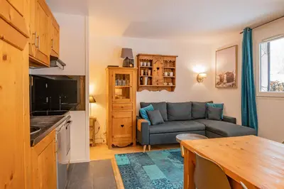 a living room with a couch and a table at Apartment Triolet Jardin - Garden with Mont Blanc Views in Chamonix-Mont-Blanc