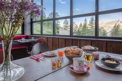 a table with breakfast foods and drinks on it at Refuge du Montenvers in Chamonix-Mont-Blanc