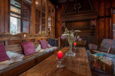 a living room with a couch and a table with candles at Refuge du Montenvers in Chamonix-Mont-Blanc