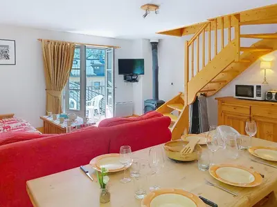 a kitchen with a table with plates and glasses on it at Apartment Conseil 3 by Interhome in Saint-Gervais-les-Bains