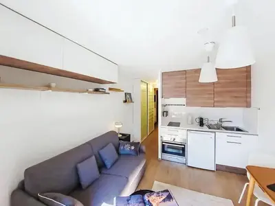 a living room with a blue couch and a table at Apartment Blanc Neige by Interhome in Chamonix-Mont-Blanc