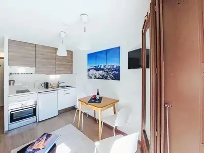a kitchen and dining room with a table and chairs at Apartment Blanc Neige by Interhome in Chamonix-Mont-Blanc