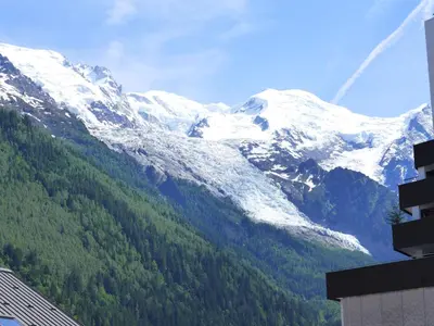 a balcony with a table and a view of a city at Apartment Blanc Neige by Interhome in Chamonix-Mont-Blanc