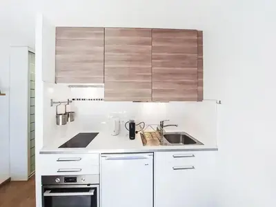 a kitchen with white cabinets and a sink at Apartment Blanc Neige by Interhome in Chamonix-Mont-Blanc