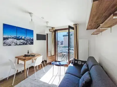 a living room with a couch and a kitchen at Apartment Blanc Neige by Interhome in Chamonix-Mont-Blanc