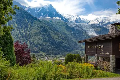 a house in the snow in front of a mountain at Auberge du Bois Prin in Chamonix-Mont-Blanc