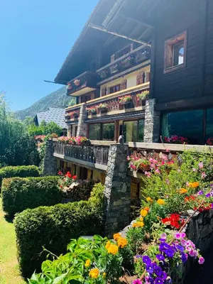 a dining room with a wooden table and chairs at Auberge du Bois Prin in Chamonix-Mont-Blanc