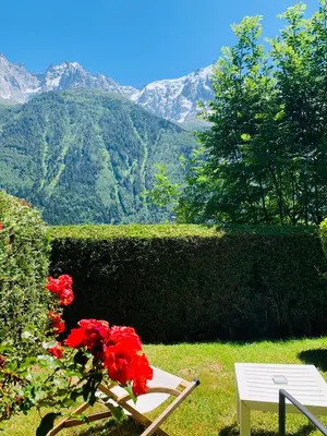 a house with a bunch of flowers in front of it at Auberge du Bois Prin in Chamonix-Mont-Blanc