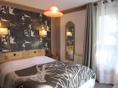 a bedroom with a bed with a deer painted on it at Logis Hotel Gai Soleil in Samoëns
