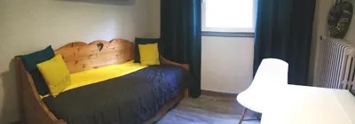 a bedroom with a wooden bed and a window at Résidence Le Fontenay in Plateau dʼAssy
