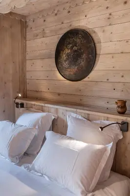 a bedroom with a wall with a clock on it at Le Cerf Amoureux Chalet Privé & Spa in Sallanches