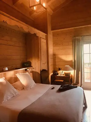 a bedroom with a bed and a desk and a window at Le Cerf Amoureux Chalet Privé & Spa in Sallanches