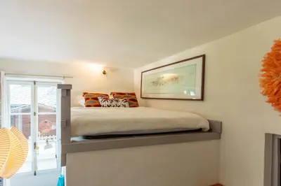 a bedroom with a bed with orange pillows on it at Appartement Cocon in Chamonix-Mont-Blanc
