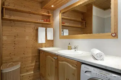 a bathroom with a sink and a washing machine at Apartment Balme 2 - Central Chamonix Haven and Mont Blanc View in Chamonix-Mont-Blanc