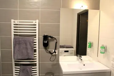 a bathroom with a sink and a phone on the wall at Appartement au pied du Mont-Blanc ! in Sallanches
