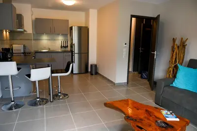 a kitchen and living room with a couch and a table at Appartement au pied du Mont-Blanc ! in Sallanches