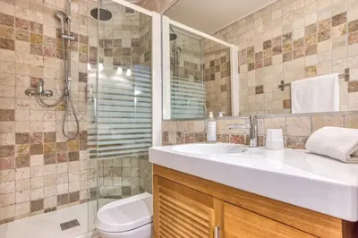 a bathroom with a sink and a shower and a toilet at Hôtel Lyret in Chamonix-Mont-Blanc