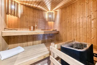 a wooden sauna with a tub in it at Hôtel Lyret in Chamonix-Mont-Blanc