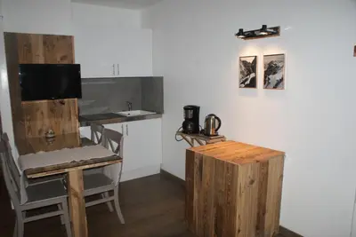 a kitchen with a counter and a table and a counter top at Champalo in Chamonix-Mont-Blanc