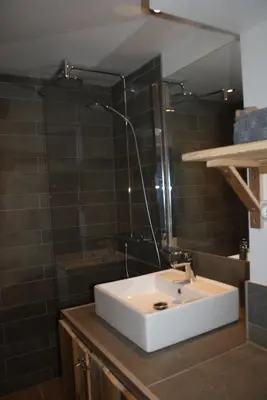a bathroom with a white sink and a shower at Champalo in Chamonix-Mont-Blanc