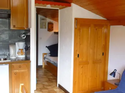 a kitchen with a door leading to a bedroom at Résidence Les Jorasses in Servoz
