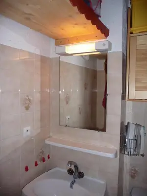 a bathroom with a sink and a mirror at Résidence Les Jorasses in Servoz