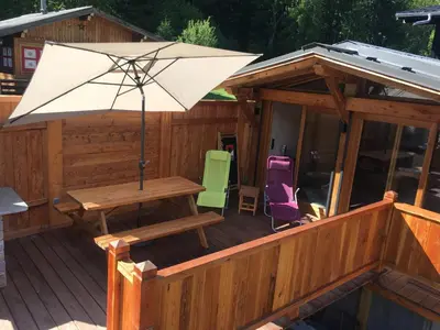 a deck with a table and an umbrella at La Para in Chamonix-Mont-Blanc