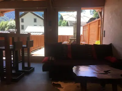 a living room with a couch and a large window at La Para in Chamonix-Mont-Blanc