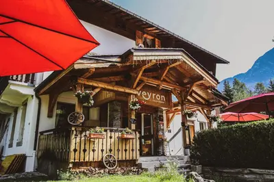 a building with a red umbrella in front of it at L'Arveyron Open House in Chamonix-Mont-Blanc