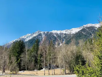 a mountain with snow capped mountains in the background at L'Arveyron Open House in Chamonix-Mont-Blanc