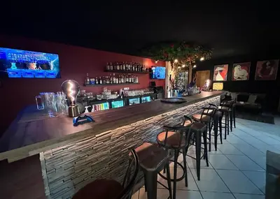 a bar with a row of bar stools at Fontaine du Mont Blanc Hotel & Spa in Les Houches