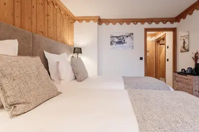 a bedroom with two beds in a room at La Ferme du Golf in Megève