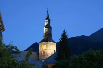 a church with a steeple on top of a building at Les Jardins Alpins - Apartment in Saint-Gervais-les-Bains