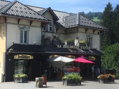 a building with an umbrella in front of it at Les Jardins Alpins - Apartment in Saint-Gervais-les-Bains