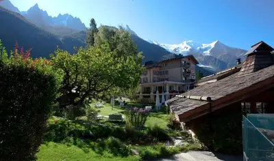 a view of a village with mountains in the background at Le Hameau Albert 1er - Relais & Châteaux in Chamonix-Mont-Blanc