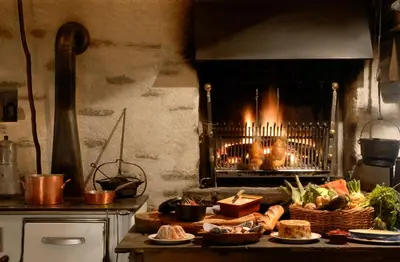 a kitchen with a stove with a fireplace at Le Hameau Albert 1er - Relais & Châteaux in Chamonix-Mont-Blanc