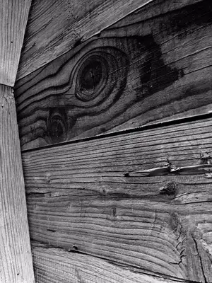 a black and white photo of a wooden wall at Duplex en vieux bois hyper centre in Chamonix-Mont-Blanc