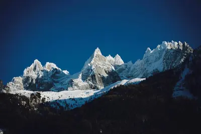 a view of a snow covered mountain range at Duplex en vieux bois hyper centre in Chamonix-Mont-Blanc