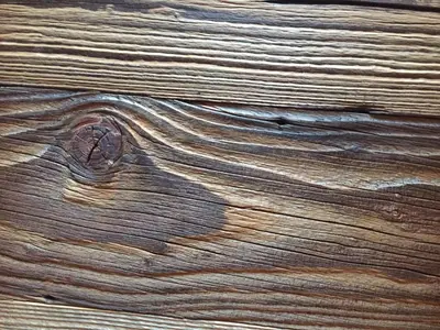 a close up of a piece of wood with a knot in it at Duplex en vieux bois hyper centre in Chamonix-Mont-Blanc
