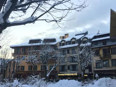 a group of buildings with snow on their roofs at Duplex en vieux bois hyper centre in Chamonix-Mont-Blanc