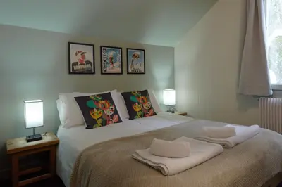 a bedroom with a bed with two towels on it at Vert Lodge Chamonix in Chamonix-Mont-Blanc