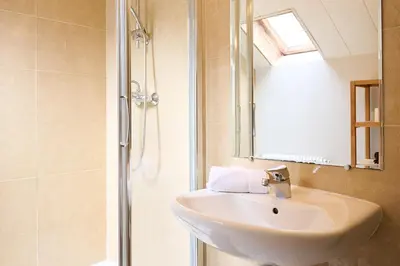 a bathroom with a sink and a shower at Vert Lodge Chamonix in Chamonix-Mont-Blanc