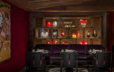 a dining room with red vases on shelves at Four Seasons Resort Megève in Megève